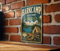 A vintage-style metal sign for Barkcamp State Park, Ohio, featuring a scenic illustration of a forest, a lake, and a tent.