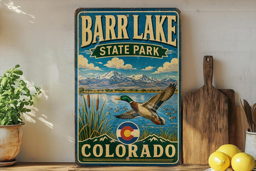 A vintage-style metal sign for Barr Lake State Park in Colorado, featuring a colorful illustration of a duck flying over a lake with mountains in the background.