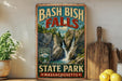 A vintage-style sign for Bash Bish Falls State Park in Massachusetts, featuring a scenic image of the waterfall surrounded by lush greenery.