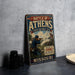 A vintage metal sign titled "Battle of Athens" is displayed on a table, featuring an illustration of a soldier with a rifle.