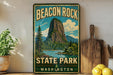 A vintage-style metal sign for Beacon Rock State Park in Washington, featuring a scenic landscape with a mountain, lake, and pine trees.