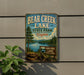 A vintage metal sign for Bear Creek Lake State Park in Virginia, featuring a scenic landscape with a lake, mountains, and trees.