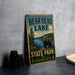A vintage-style metal sign for Bear Head Lake State Park in Minnesota, featuring a bear and a scenic landscape.
