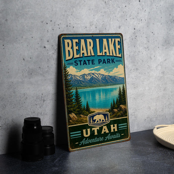 A vintage metal sign for Bear Lake State Park in Utah, featuring a scenic landscape with mountains, pine trees, and a lake.