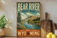 A vintage-style metal sign for Bear River State Park, featuring a scenic landscape with a river, mountains, and pine trees.