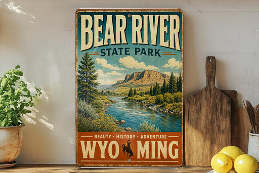 A vintage-style metal sign for Bear River State Park, featuring a scenic landscape with a river, mountains, and pine trees.