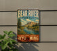 A vintage-style metal sign for Bear River State Park, featuring a scenic landscape with mountains, trees, and a river.