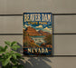 A vintage-style sign for Beaver Dam State Park in Nevada, featuring a scenic illustration of the park's landscape with a waterfall.