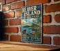 A vintage-style metal sign for Beaver Island State Park in New York, featuring a scenic illustration of a bear and a lake surrounded by trees.