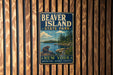 A vintage metal sign for Beaver Island State Park, featuring a scenic image of a beaver and a lake surrounded by trees.