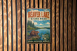 A vintage metal sign for Beaver Lake State Park, featuring an illustration of a beaver and a scenic landscape with a lake and trees.