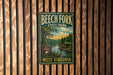 A vintage metal sign for Beech Fork State Park in West Virginia, featuring a scenic illustration of a lake and forest.