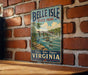 A vintage-style metal sign for Belle Isle State Park in Virginia, featuring a scenic illustration of a river and bridge.