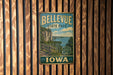 A vintage-style metal sign for Bellevue State Park in Iowa, featuring a scenic landscape with a river and cliffs.