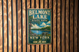 A vintage metal sign for Belmont Lake State Park in New York, featuring a scenic illustration of the lake and surrounding landscape.