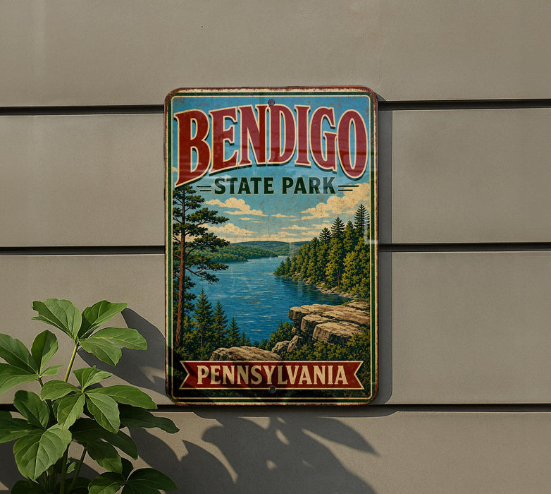 A vintage metal sign for Bendigo State Park in Pennsylvania, featuring a scenic landscape with a lake, mountains, and pine trees.