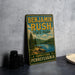 A vintage-style sign for Benjamins Rush State Park in Pennsylvania, featuring a scenic landscape with pine trees, a lake, and mountains.