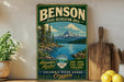 A vintage-style sign for Benson State Recreation Area, featuring a scenic mountain landscape with a lake and pine trees.