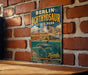 A vintage-style metal sign for Berlin-Ichthyosaur State Park, featuring an illustration of a sea dinosaur and the text "Berlin-Ichthyosaur State Park" and "Nebraska".