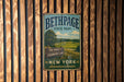 A vintage metal sign for Bethpage State Park, featuring a scenic landscape with a golf course and trees, mounted on a wooden wall.