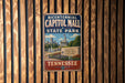 A vintage-style metal sign for the historic Capitol Mall State Park in Tennessee, featuring a cityscape and the text "Bicentennial Capitol Mall State Park" in a patriotic design.