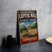 A vintage-style metal sign for the historic Capitol Mall State Park in Tennessee, featuring an illustration of the capitol building and surrounding scenery.