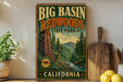 A vintage-style sign for Big Basin Redwoods State Park in California, featuring a scenic image of the park's landscape.