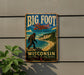 A vintage-style metal sign for Big Foot Beach State Park in Wisconsin, featuring a large Sasquatch figure and a scenic landscape.