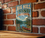A vintage-style metal sign for Big Hill Pond State Park in Tennessee, featuring a scenic illustration of a lake, forest, and canoe.