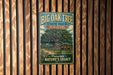 A vintage-style metal sign for Big Oak Tree State Park in Missouri, featuring an illustration of a large oak tree and a path leading to the park.