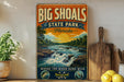 A vintage-style sign for Big Shoals State Park in Florida, featuring a scenic illustration of a river flowing through a lush landscape with a sunset in the background.