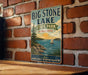 A vintage-style metal sign for Big Stone Lake, Minnesota, featuring a scenic illustration of the lake and surrounding landscape.