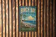 A vintage-style metal sign for Birch Bay State Park in Washington, featuring a scenic landscape with a sailboat on the water.
