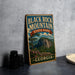 A vintage-style sign for Black Rock Mountain State Park in Georgia, featuring a scenic illustration of the mountain landscape.