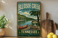 A vintage-style sign for Bledsoe Creek State Park in Tennessee, featuring a canoe on the shore and a scenic landscape.