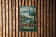 A vintage metal sign for Bledsoe Creek State Park in Tennessee, featuring a scenic image of a lake, canoe, and mountains.