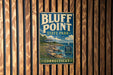 A vintage-style sign for Bluff Point State Park in Connecticut, featuring a scenic coastal landscape with a sailboat and rocky shoreline.
