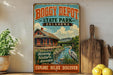 A vintage-style sign for BOGGY DEPOT STATE PARK, Oklahoma, featuring a train station and a bird in the foreground.