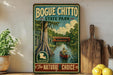 A vintage-style sign for Bogue Chitto State Park, featuring a painting of a person in a red boat on a river surrounded by lush greenery.