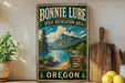 A vintage-style sign for Bonnie Lure State Recreation Area in Oregon, featuring a scenic mountain landscape with a lake and pine trees.