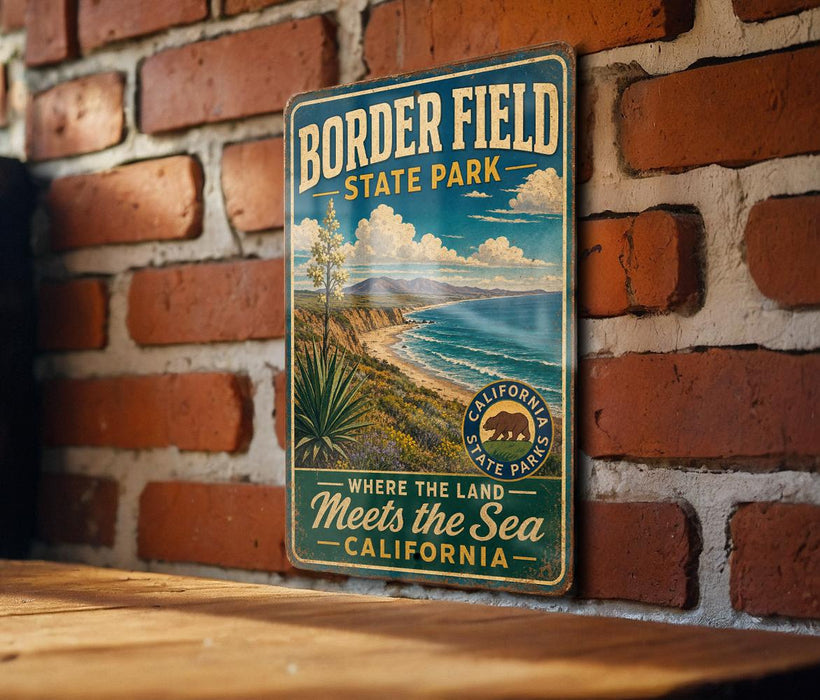 A vintage metal sign for Border Field State Park, featuring a scenic landscape with a desert, ocean, and mountains.
