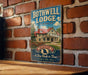 A vintage-style metal sign for the Bothwell Lodge, a historic lodge in Missouri, is displayed on a brick wall.