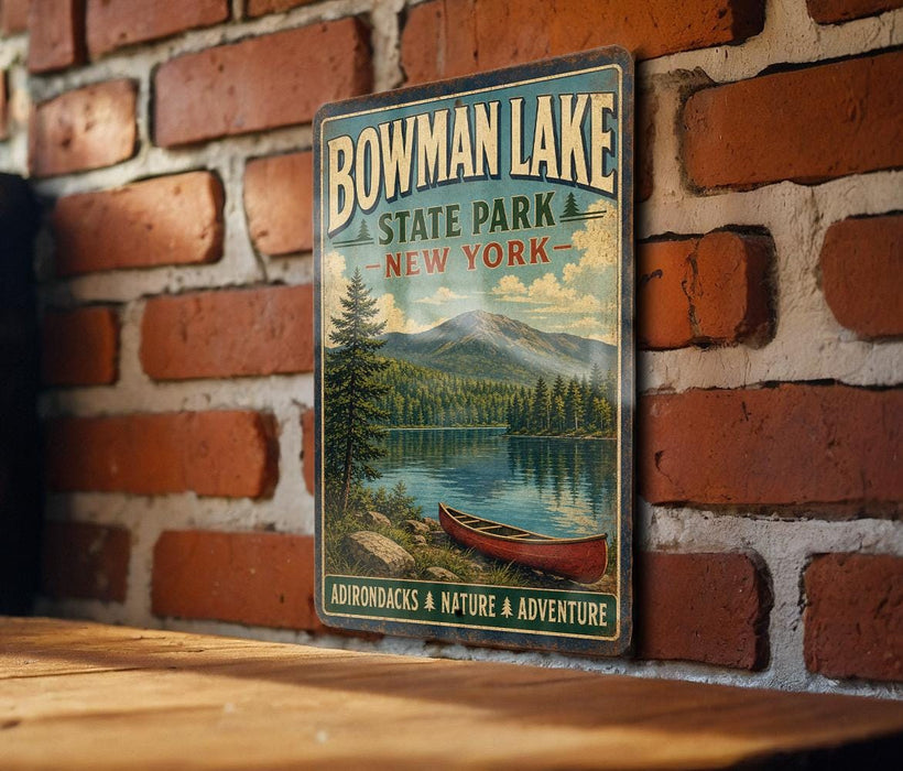 A vintage-style metal sign for Bowman Lake State Park in New York, featuring a scenic image of a lake with a red canoe and a mountain backdrop.
