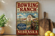 A vintage-style metal sign for Bowring Ranch State Historical Park in Nebraska, featuring a barn, windmill, and other rural elements.