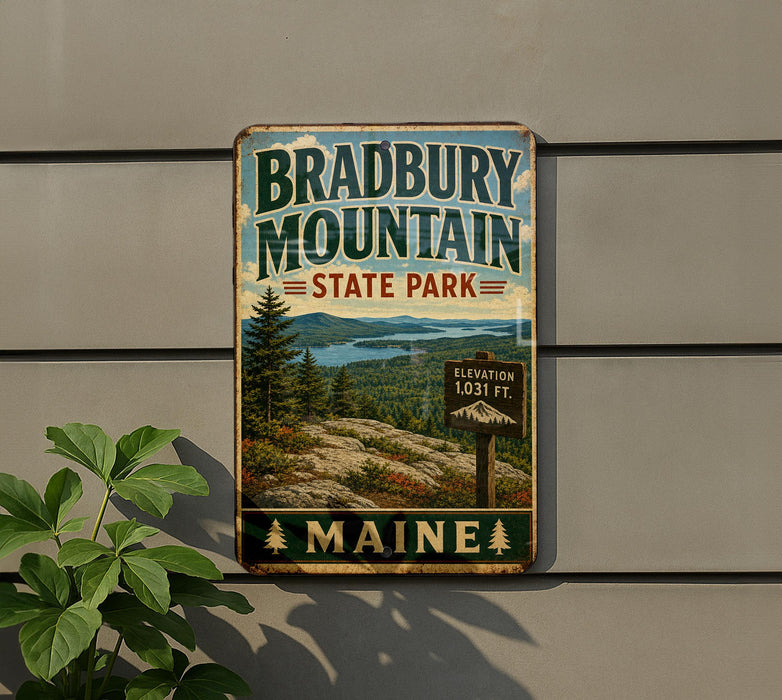 A vintage metal sign for Bradbury Mountain State Park in Maine, featuring a scenic landscape with pine trees, mountains, and a lake.