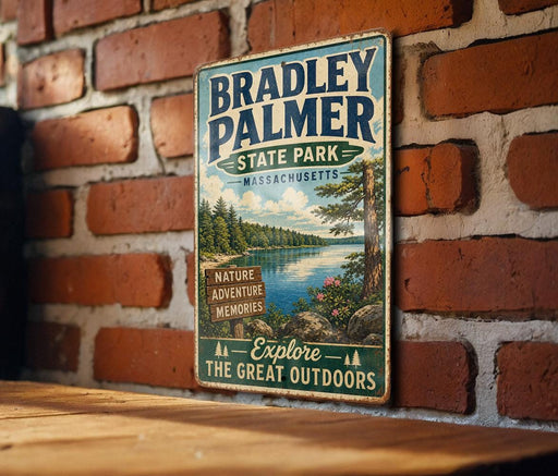 A vintage metal sign for Bradley Palmer State Park in Massachusetts, featuring a scenic landscape with a lake and trees.