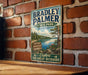 A vintage metal sign for Bradley Palmer State Park in Massachusetts, featuring a scenic landscape with a lake and trees.