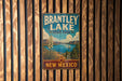 A vintage metal sign for Brantley Lake State Park in New Mexico, featuring a scenic illustration of the lake and surrounding landscape.