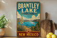 A vintage-style sign for Brantley Lake State Park in New Mexico, featuring a scenic landscape with a lake, mountains, and a sailboat.