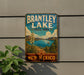 A vintage-style sign for Brantley Lake State Park in New Mexico, featuring a scenic landscape with mountains, a lake, and a palm tree.